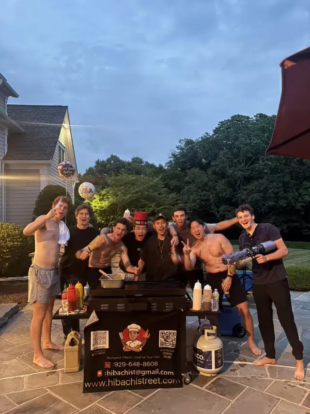 A group gathered around the hibachi grill